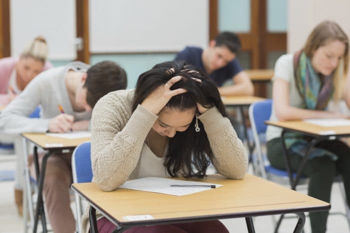 Stressed student sitting in a cl